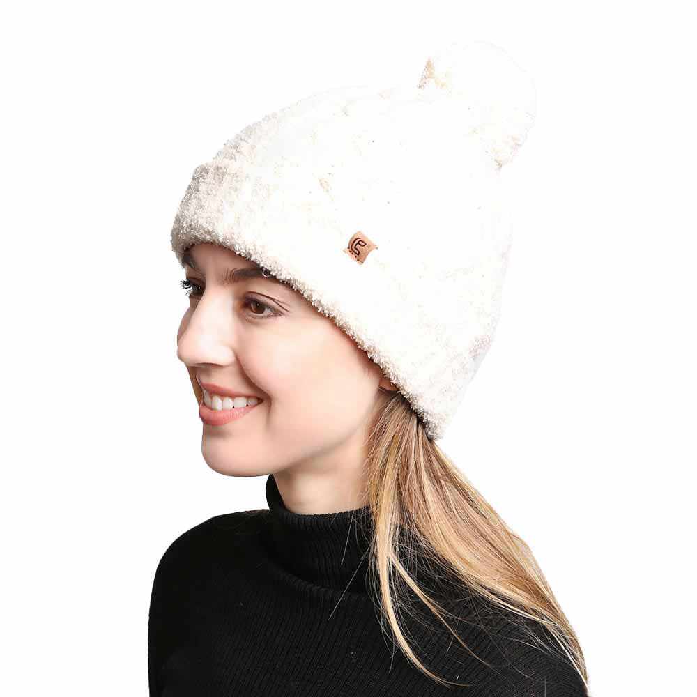 Ivory Solid Color Cable Knit Beanie. Accessorize the fun way with this pom cable knit Beanie. The autumnal touch you need to finish your outfit in style. Cable knit Beanie made with warm poly microfiber to ensure maximum comfort and durability. Ideal winter head cover! Comes in one size winter cap with a pom that fits most head sizes. Absolutely the perfect gift winter accessory!