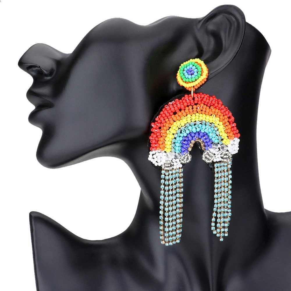 Multi Rhinestone Seed Beaded Rainbow Dangle Earrings, these fun multicolored beaded dangle are perfect for making a statement. Adding a feminine touch to any outfit with these intricately seed beaded dangle earrings. You can rock this look with tops and jeans, or make it elegant with a classic dress and heels, you're sure to love these trendy rainbow dangle earrings all year long! Definitely making every woman feel bold, beautiful, and confident.