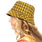 Mustard Polyester Geometric Patterned Bucket Hat, this bucket hat doubles as a rain hat and is snug on the head and stays on well. It will work well to keep the rain off the head and out of the eyes and also the back of the neck. Wear it to lend a modern liveliness above a raincoat on trans-seasonal days in the city.