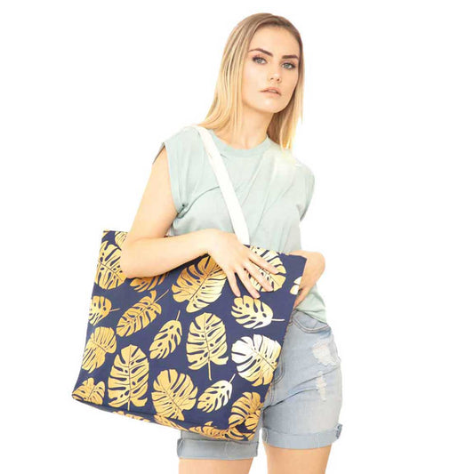 Navy Tropical Leaves Foil Beach Bag, Show your trendy side with this awesome Flower & Leaf beach tote bag. Spacious enough for carrying any and all of your seaside essentials. The soft rope straps really helps carrying this shoulder bag comfortably. Folds flat for easy packing. Perfect as a beach bag to carry foods, drinks, big beach blanket, towels, swimsuit, toys, flip flops, sun screen and more.