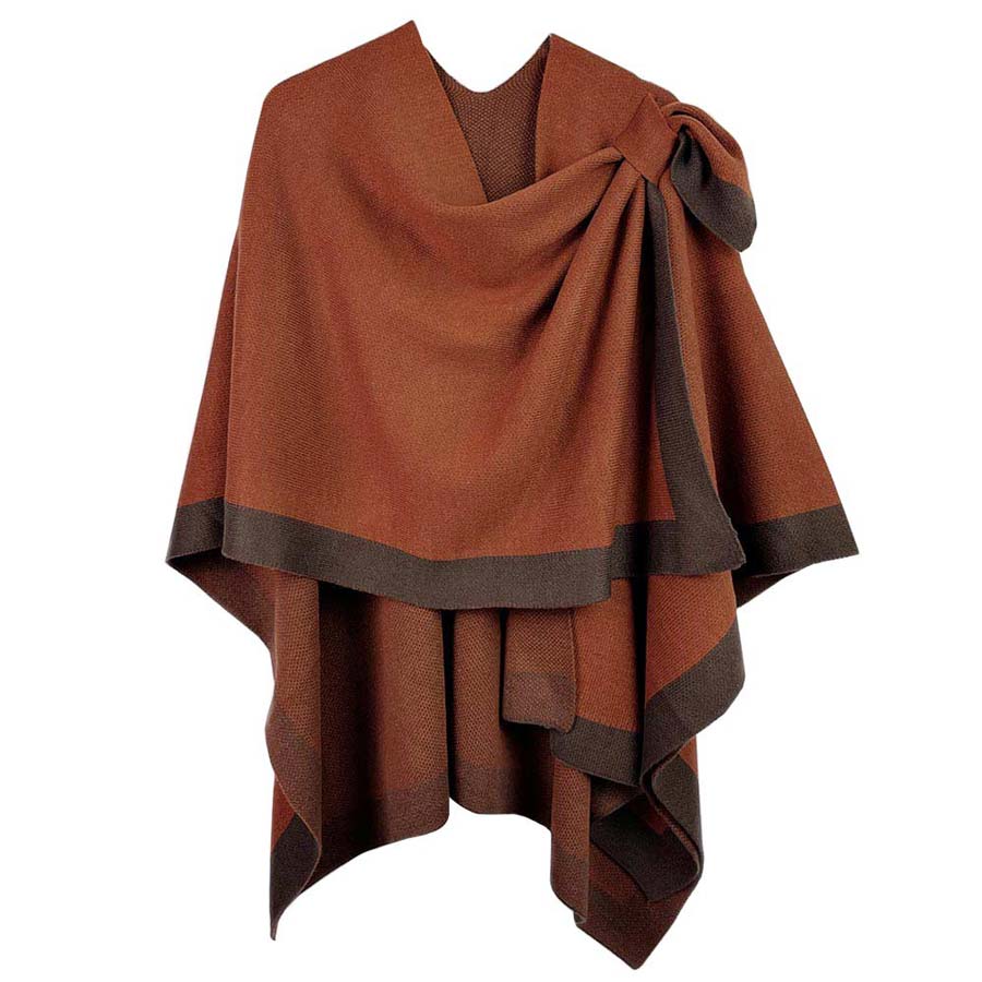 Rust Bordered Ruana With Shoulder Strap, is beautifully designed with a border and shoulder strap that will absolutely accent your outlook to a greater extent and keeps you warm and comfortable on cold days. The shoulder strap is so unique and attractive that will surely make you stand out with a unique yet trendy style. It will keep you perfectly warm and toasty everywhere saving you from cold and chill on the outside.